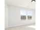Bright bedroom with two windows providing natural light and a glimpse of the outdoor landscape at 736 Ocmulgee Xing, Locust Grove, GA 30248