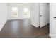 Bright bedroom boasting hardwood floors, two windows, and white closet doors at 736 Ocmulgee Xing, Locust Grove, GA 30248