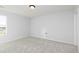 Bright bedroom with neutral carpet, white walls, and a window offering natural light at 736 Ocmulgee Xing, Locust Grove, GA 30248