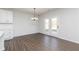 Dining area with double doors, hardwood floors, and a modern chandelier at 736 Ocmulgee Xing, Locust Grove, GA 30248