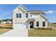 Charming two-story home featuring a brick facade, two-car garage, and manicured lawn at 736 Ocmulgee Xing, Locust Grove, GA 30248