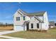 Beautiful two-story home showcasing a well-kept lawn and brick exterior details at 736 Ocmulgee Xing, Locust Grove, GA 30248