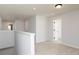 Upstairs hallway with neutral carpet and white doors, with a view into several rooms at 736 Ocmulgee Xing, Locust Grove, GA 30248