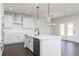 Modern kitchen with white cabinets, stainless appliances, and a central island with a dishwasher at 736 Ocmulgee Xing, Locust Grove, GA 30248