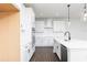 Open kitchen features a central island, modern appliances, and stylish pendant lighting at 736 Ocmulgee Xing, Locust Grove, GA 30248