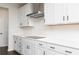 Bright kitchen with white cabinets, white subway tile backsplash, and stainless range hood at 736 Ocmulgee Xing, Locust Grove, GA 30248