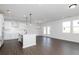 Open-concept kitchen featuring an island, stainless steel appliances, and hardwood floors at 736 Ocmulgee Xing, Locust Grove, GA 30248