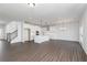 Open floor plan with a central island, stainless appliances, and hardwood flooring at 736 Ocmulgee Xing, Locust Grove, GA 30248
