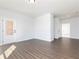 Spacious living room featuring hardwood floors, and a modern white door at 736 Ocmulgee Xing, Locust Grove, GA 30248