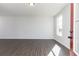 Bright living room with hardwood floors and a sunny window at 736 Ocmulgee Xing, Locust Grove, GA 30248