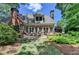 Spacious backyard featuring a stone patio, lush lawn, and manicured landscaping, creating a private retreat at 1830 Hadfield Blvd, Roswell, GA 30075