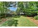 Expansive backyard with lush green lawn, mature trees, and landscaping providing a serene outdoor space at 1830 Hadfield Blvd, Roswell, GA 30075