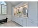 Bright bathroom features a double vanity, decorative window, and modern lighting at 1830 Hadfield Blvd, Roswell, GA 30075