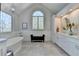 Luxury bathroom with a soaking tub, stylish window, and double sink vanity at 1830 Hadfield Blvd, Roswell, GA 30075