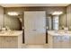 Bathroom with two sinks, two mirrors, and linen storage at 1830 Hadfield Blvd, Roswell, GA 30075