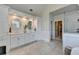 Bright bathroom with walk-in shower, tiled floors, and dual vanities with storage at 1830 Hadfield Blvd, Roswell, GA 30075