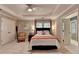 Bedroom with a tray ceiling, a queen bed and ensuite bath with classic styling at 1830 Hadfield Blvd, Roswell, GA 30075