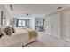 Bright bedroom showcases two beds, a seating area, and closet doors for plenty of storage space at 1830 Hadfield Blvd, Roswell, GA 30075