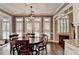 Dining area with a chandelier, large windows, and access to the kitchen at 1830 Hadfield Blvd, Roswell, GA 30075