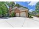 Spacious home featuring a large driveway and an attached two-car garage, offering convenient parking and storage at 1830 Hadfield Blvd, Roswell, GA 30075