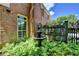 Ornate fountain surrounded by ferns and lush foliage, adding a serene touch to the backyard of brick home at 1830 Hadfield Blvd, Roswell, GA 30075