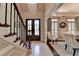 Bright foyer with hardwood floors, staircase, and dining room, creating an elegant and open entrance at 1830 Hadfield Blvd, Roswell, GA 30075