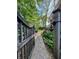 Stone garden path leads through lush greenery towards the home, with a charming wooden gate and fountain at 1830 Hadfield Blvd, Roswell, GA 30075