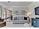 Inviting living room with gray couch, hardwood floors, and view into dining area at 1830 Hadfield Blvd, Roswell, GA 30075