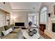 Comfortable living room with fireplace, hardwood floors, and natural light, connecting to the dining area at 1830 Hadfield Blvd, Roswell, GA 30075