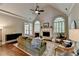 Bright living room with fireplace, high ceilings, and large windows, offering a cozy and inviting space at 1830 Hadfield Blvd, Roswell, GA 30075