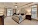 Spacious main bedroom boasts a tray ceiling, chandelier, and neutral décor at 1830 Hadfield Blvd, Roswell, GA 30075