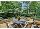 Secluded patio showcases a wrought iron table and chairs, perfect for outdoor dining and relaxation at 1830 Hadfield Blvd, Roswell, GA 30075