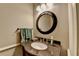 Elegant powder room with granite countertop, round mirror, and stylish fixtures at 1830 Hadfield Blvd, Roswell, GA 30075