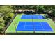 Aerial view of community tennis courts with green and blue surface at 1830 Hadfield Blvd, Roswell, GA 30075