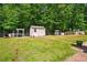 Spacious backyard featuring shed, mature trees, arbors, and stone path at 245 Tapestry Dr, Mcdonough, GA 30252