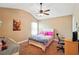 Bright bedroom featuring a bed, desk, and ceiling fan at 245 Tapestry Dr, Mcdonough, GA 30252