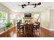Elegant dining room with hardwood floors, multiple ceiling fans, and natural light, perfect for gatherings at 245 Tapestry Dr, Mcdonough, GA 30252
