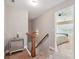 Upstairs hallway with decorative table and a view of the bedroom at 245 Tapestry Dr, Mcdonough, GA 30252