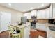 The spacious kitchen features granite counters, stainless appliances and an island with barstool seating at 245 Tapestry Dr, Mcdonough, GA 30252