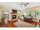 Bright living room with stone fireplace, hardwood floors, and ample natural light offers a welcoming space at 245 Tapestry Dr, Mcdonough, GA 30252