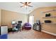 Home office with carpeting, vaulted ceiling, fan, and white floating shelving for storage at 245 Tapestry Dr, Mcdonough, GA 30252