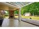 Back patio featuring outdoor fireplace, shed, mature trees, and covered seating area at 245 Tapestry Dr, Mcdonough, GA 30252