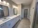 Well-lit bathroom features a double vanity, shower, and sleek design for a spa-like experience at 2503 Wollerton St # 2503, Cumming, GA 30040