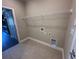 Functional laundry room with storage shelf and tiled flooring at 2503 Wollerton St # 2503, Cumming, GA 30040