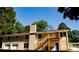 Spacious backyard with a deck, stairs, and garage, offering ample outdoor living space at 2751 Colonial Dr, College Park, GA 30337