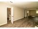 Open layout of finished basement with plank floors, and a bathroom at 2751 Colonial Dr, College Park, GA 30337