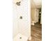 Bathroom featuring a tiled shower, neutral paint, and wood-look flooring at 2751 Colonial Dr, College Park, GA 30337
