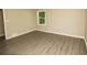 Spacious bedroom featuring wood-look flooring, neutral paint and bright natural light at 2751 Colonial Dr, College Park, GA 30337