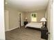 Neutral bedroom featuring luxury vinyl flooring, a closet and an ensuite bathroom at 2751 Colonial Dr, College Park, GA 30337