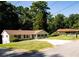 Charming single-story home with a manicured lawn, mature trees, blue shutters, and a paved driveway at 2751 Colonial Dr, College Park, GA 30337